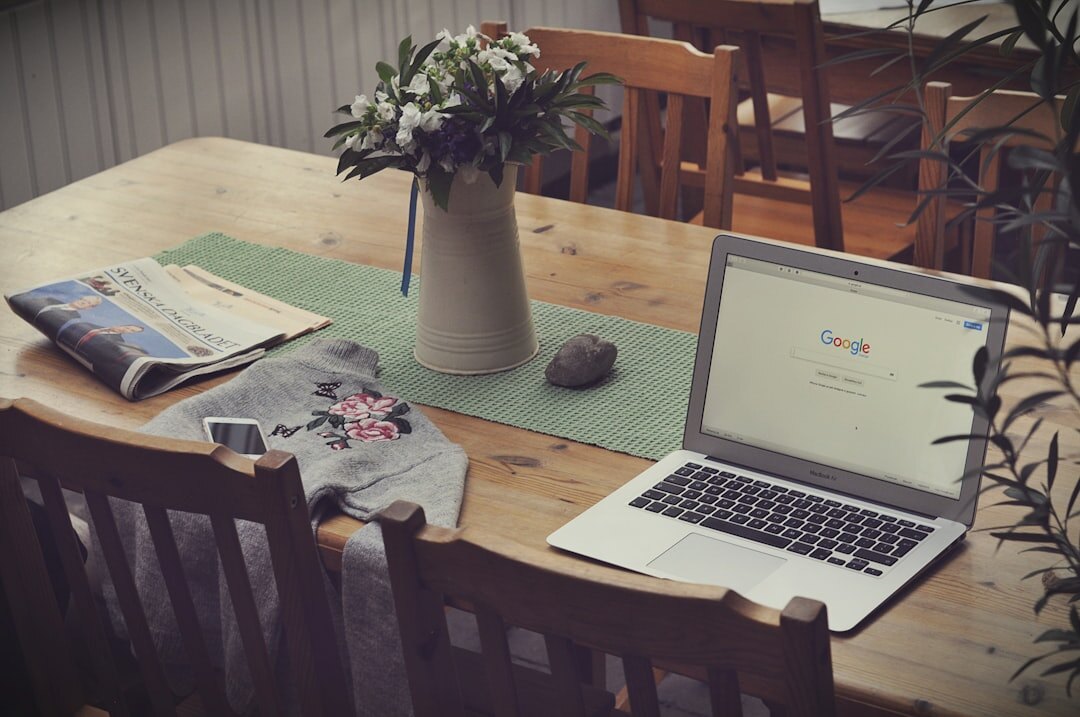Overhead view of a journalist's desk with notebook, coffee and laptop