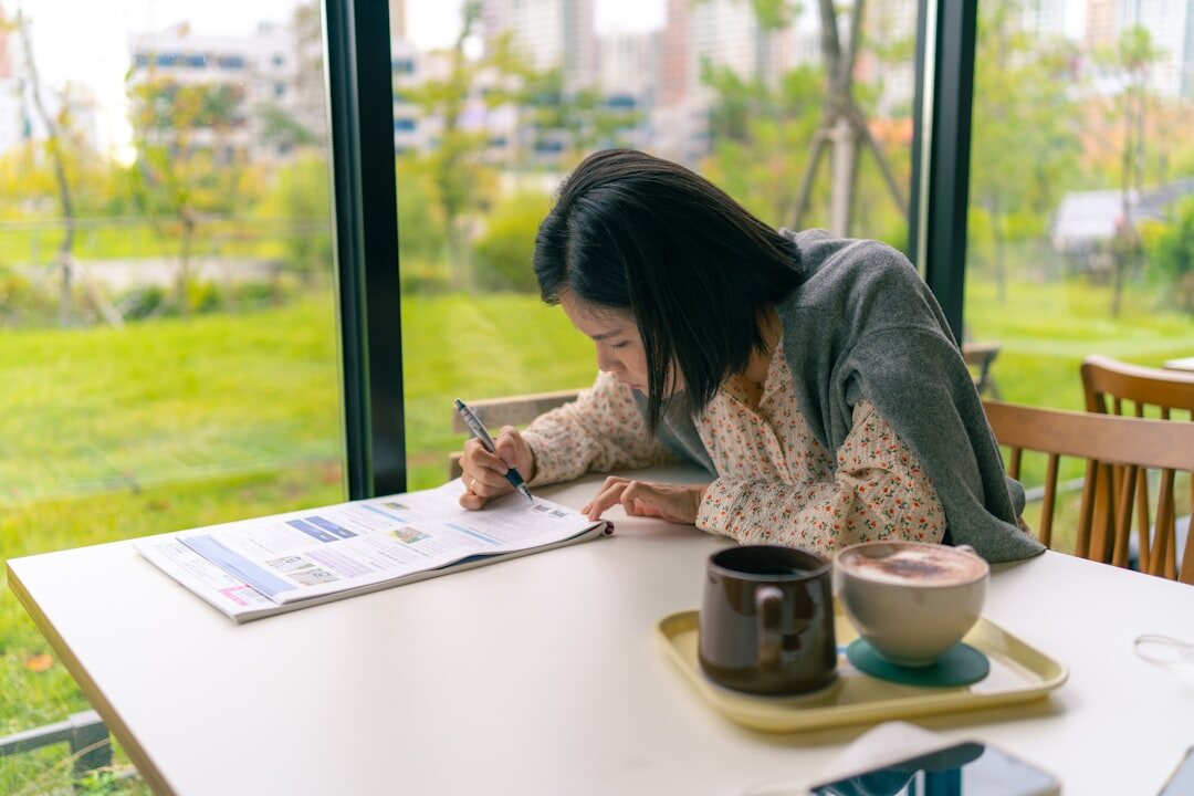 woman writing novel at cafe