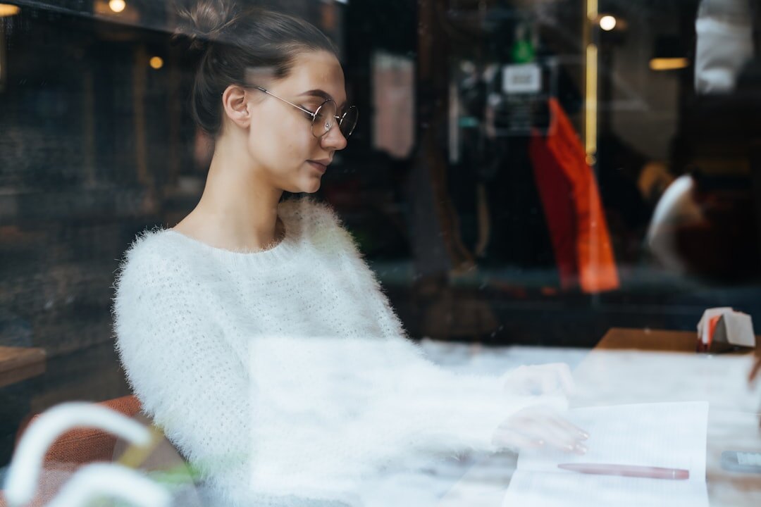 woman writing novel at cafe